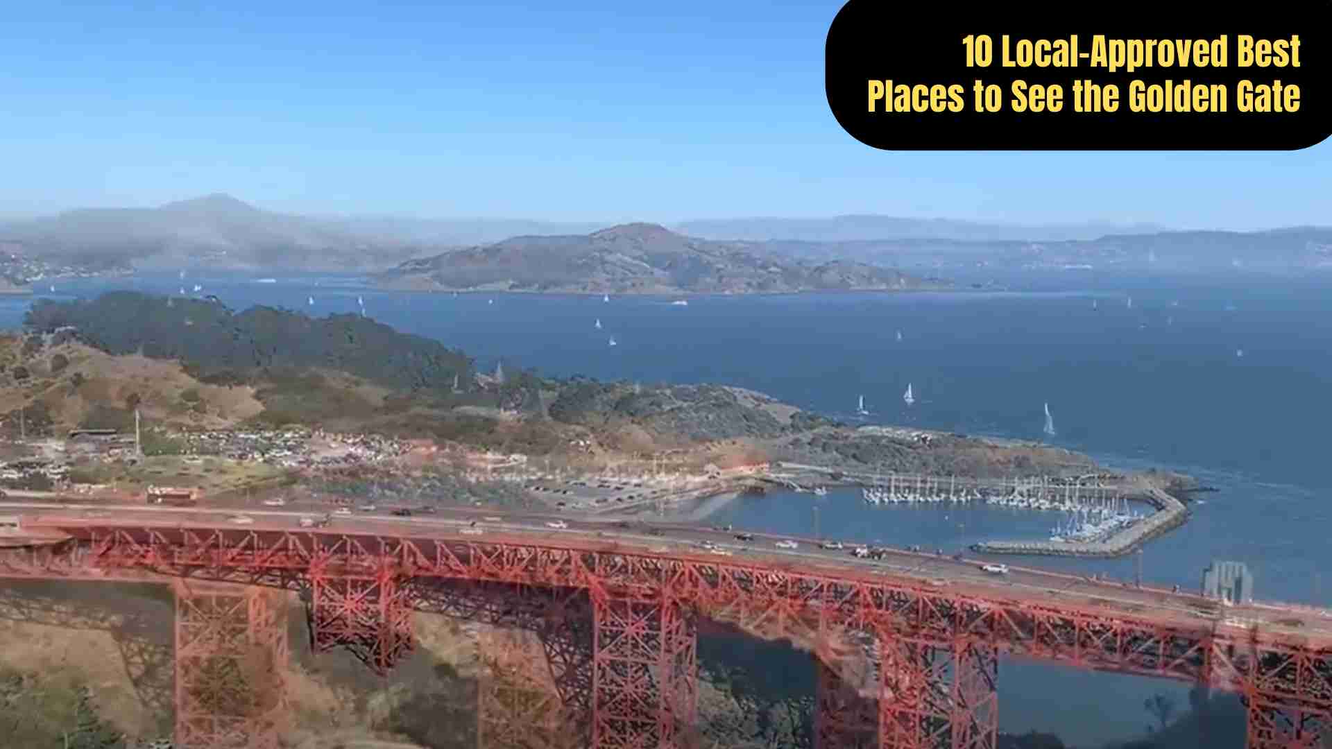 Golden Gate Bridge viewed from Battery Spencer at sunrise, its fiery orange towers glowing through morning fog above the blue waters of San Francisco Bay.