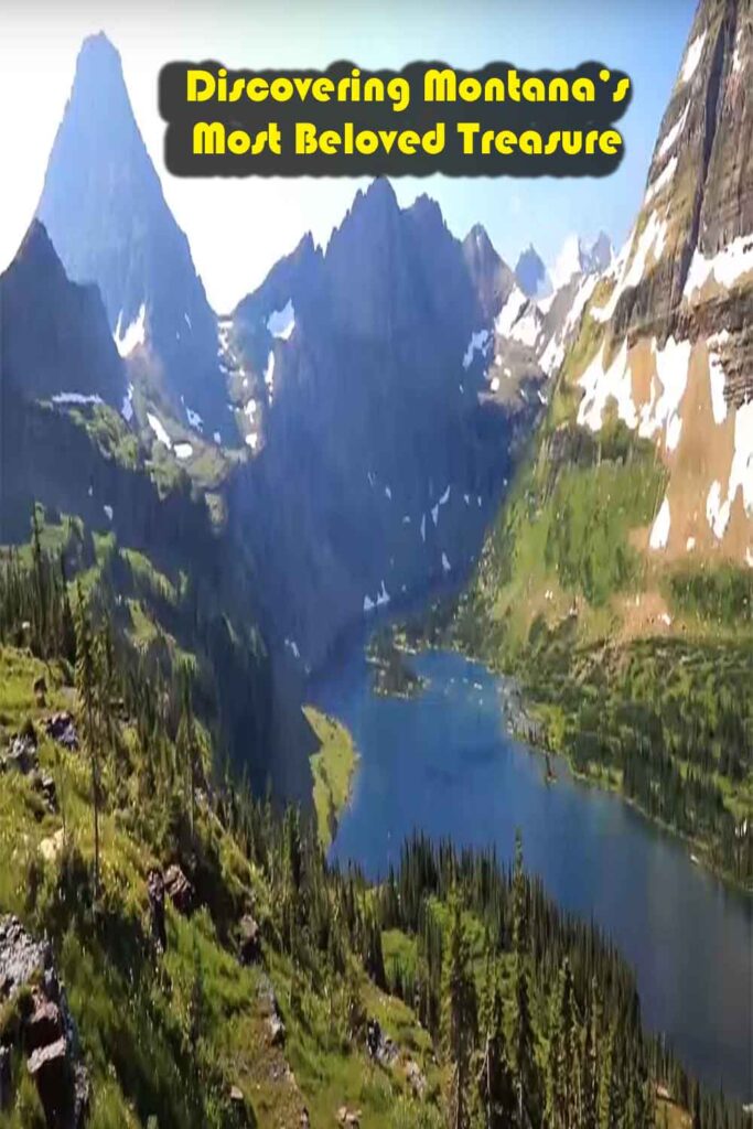 Panoramic view of Glacier National Park, Montana, featuring turquoise lakes, snow-capped mountains, and lush forests under a clear sky.